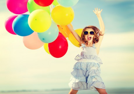 summer holidays, celebration, children and people concept - happy jumping girl with colorful balloon