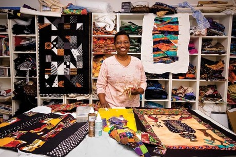 Carole-Lyles-Shaw in front of her quilt